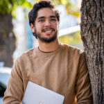 student with laptop in hand