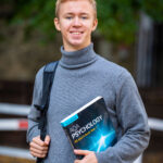 Psychology book in student's hand