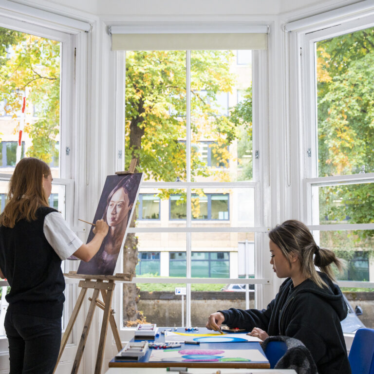 student painting a canvas