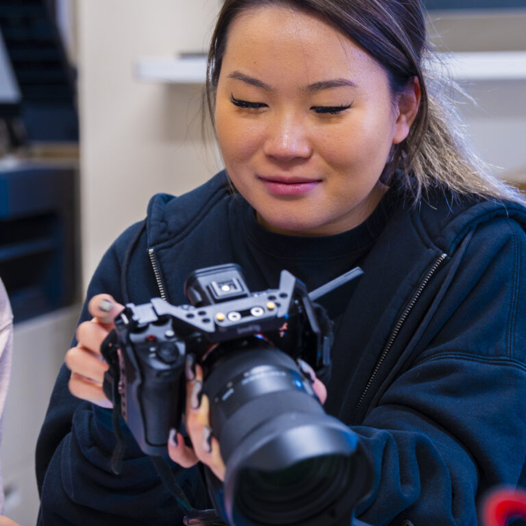student working with a camera