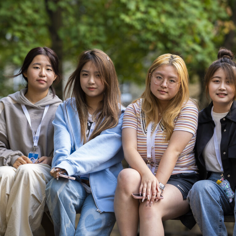 4 girls sat on a bench for a photo