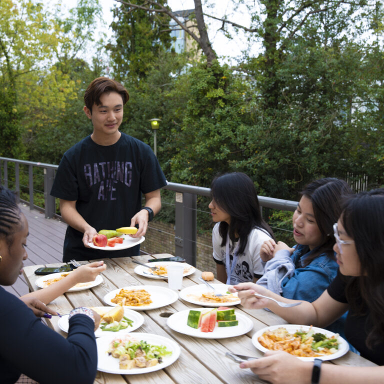 students eating fruit and other food outside