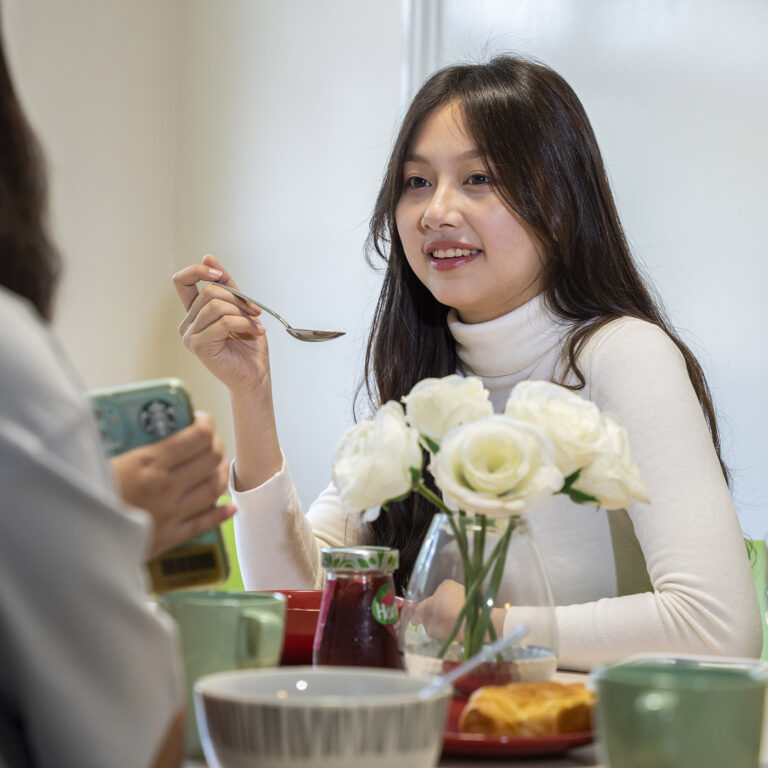 student with spoon in her hand