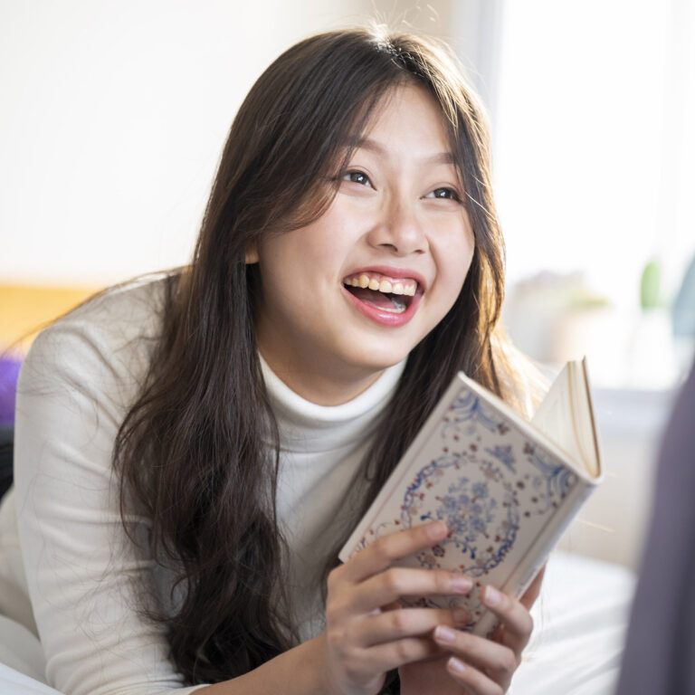 girl reading on her bed