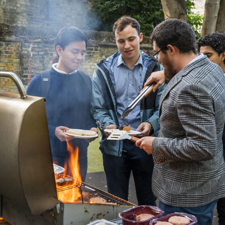 students taking food from a barbeque