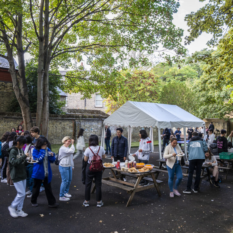 students outside in a marquee area