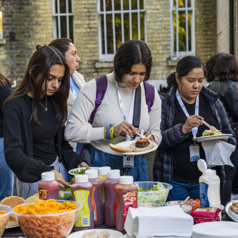 students picking up food to add to their plates